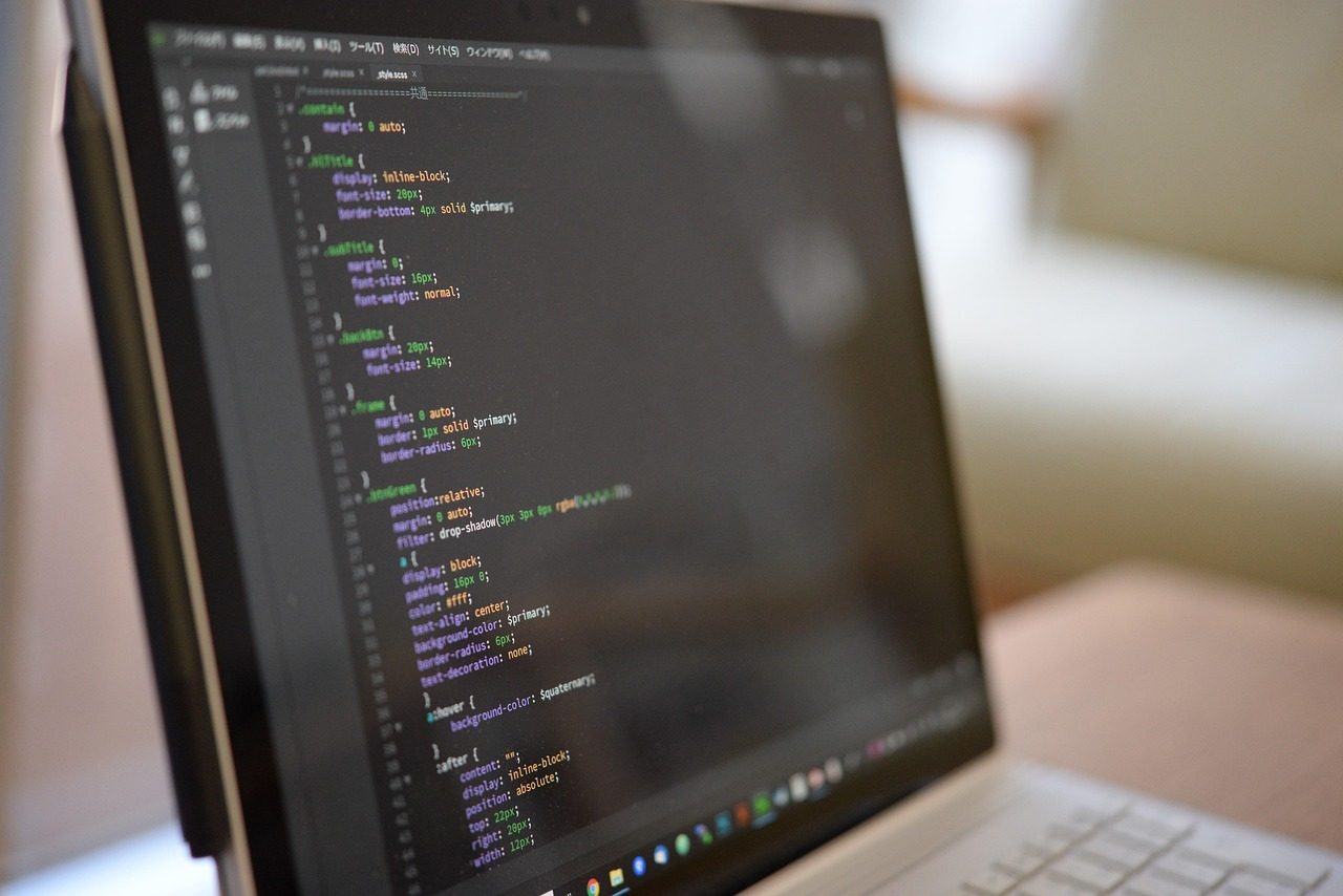 A laptop showing stylesheet code in a dark-themed editor