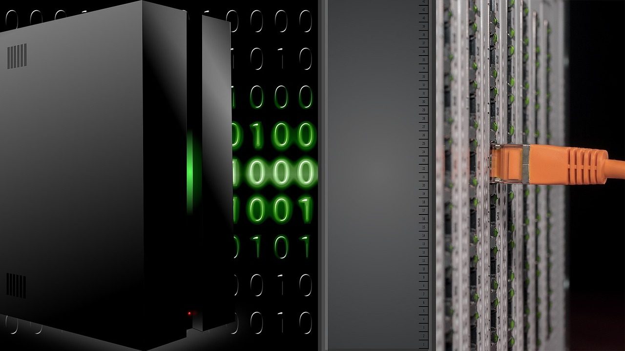 A server and a network switch connected by an orange Ethernet cable